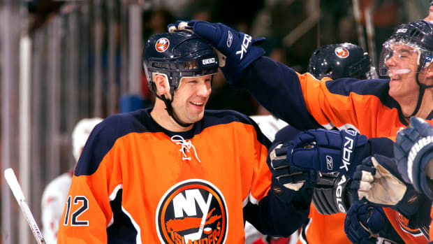New York Islanders left wing Chris Simon (12) celebrates with teammates against the Carolina Hurricanes at Nassau Veterans Memorial Coliseum in Uniondale, N.Y., on Oct. 21, 2006.