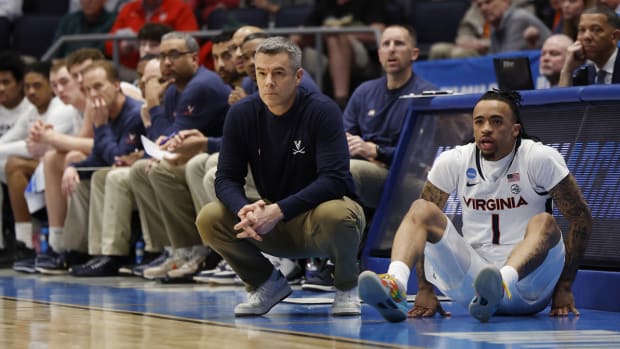 Tony Bennett coaches the Virginia Cavaliers from the bench area.