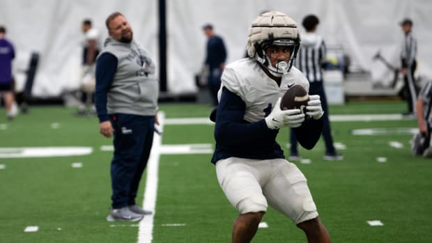 Penn State offensive coordinator Andy Kotelnicki watches running back Nicholas Singleton run through a drill during practice at Holuba Hall.