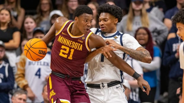 Butler Bulldogs forward Jalen Thomas (1) attempts to steal the ball away from Minnesota Golden Gophers forward Pharrel Payne (21) during the first half of an NCAA/NIT game, Tuesday, March 19, 2024, at Hinkle Fieldhouse on the campus of Butler University in Indianapolis.  