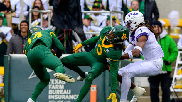 Nov 19, 2022; Waco, Texas, USA; TCU Horned Frogs safety Abraham Camara (14) intercepts a pass intended for TCU Horned Frogs wide receiver Quentin Johnston (1) as cornerback Mark Milton (3) defends during the second half at McLane Stadium. Mandatory Credit: Jerome Miron-USA TODAY Sports  