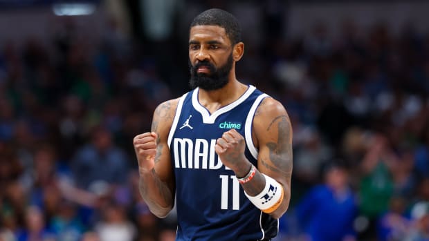 Dallas Mavericks guard Kyrie Irving clenches his fists.
