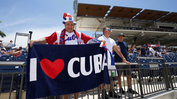 May 31, 2021; West Palm Beach, Florida, USA; A fan of the Cuban team holds a flag during the WBSC Baseball Americas Qualifier series of baseball games between Cuba and Venezuela at The Ballpark of the Palm Beaches.