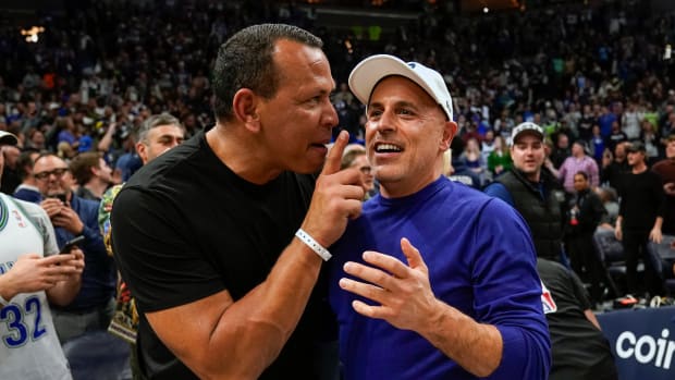 Apr 12, 2022; Minneapolis, Minnesota, USA; Minnesota Timberwolves co-minority owners Alex Rodriguez and Marc Lore celebrate a victory over the Los Angeles Clippers after a play-in game at Target Center. 