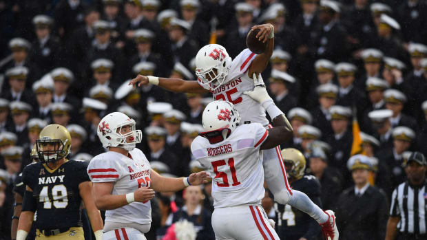 Oct 8, 2016; Annapolis, MD, USA; Houston Cougars running back Dillon Birden (25) celebrates with offensive lineman Na'Ty Rodgers (51) after scoring a touchdown during the second quarter against the Navy Midshipmen at Navy Marine Corps Memorial Stadium. Mandatory Credit: Tommy Gilligan-USA TODAY Sports  