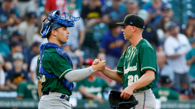Jul 8, 2023; Seattle, Washington, USA; National League Futures relief pitcher Patrick Monteverde (20) of the Miami Marlins shakes hands with catcher Dalton Rushing (20) of the Los Angeles Dodgers following a 5-0 victory against the American League Futures in the All Star-Futures Game at T-Mobile Park. Mandatory Credit: Joe Nicholson-USA TODAY Sports  