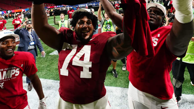 Dec 2, 2023; Atlanta, GA, USA; Alabama Crimson Tide offensive lineman Kadyn Proctor (74) celebrates with the trophy after defeating the Georgia Bulldogs in the SEC Championship at Mercedes-Benz Stadium.