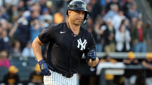Yankees designated hitter Giancarlo Stanton rounds the bases after hitting a home run in a spring training game.