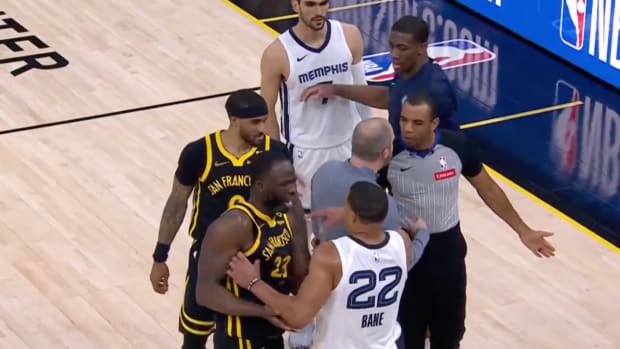 Warriors forward Draymond Green and Grizzlies guard Desmond Bane get into a sideline scuffle.
