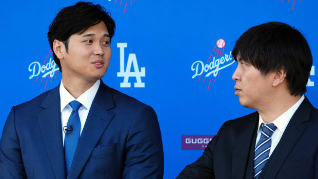 Los Angeles Dodgers designated hitter Shohei Ohtani speaks to interpreter Ippei Mizuhara at an introductory press conference.