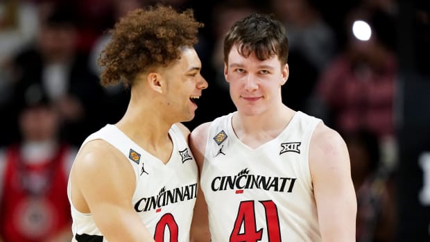 Cincinnati Bearcats guard Dan Skillings Jr. (0) congratulates Cincinnati Bearcats guard Simas Lukosius (41) on a made 3-point basket in the second half of a college basketball game in the National Invitation Tournament, Wednesday, March 20, 2024, at Fifth Third Arena in Cincinnati.  