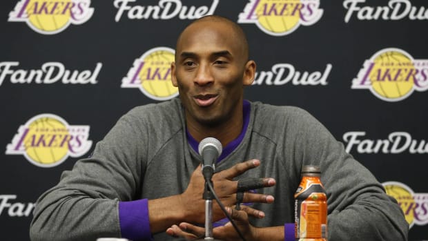 Former Lakers guard Kobe Bryant speaks with media at a press conference.