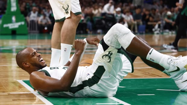 Milwaukee Bucks forward Khris Middleton (22) grimaces after being knocked down during the second half against the Boston Celtics