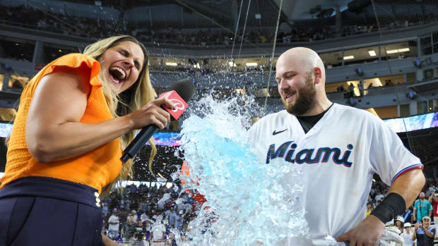 Aug 13, 2023; Miami, Florida, USA; Miami Marlins third baseman Jake Burger (36) gets dunked with energy drink after hitting a walk-off single against the New York Yankees as Bally Sports reporter Jessica Blaylock reacts at loanDepot Park. Mandatory Credit: Sam Navarro-USA TODAY Sports  