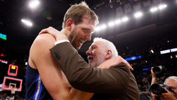 Dallas Mavericks power forward Dirk Nowitzki hugs San Antonio Spurs head coach Gregg Popovich after their game against the San Antonio Spurs.