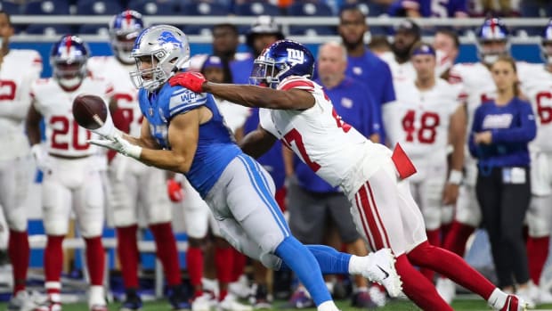 Detroit Lions tight end Sam LaPorta (87) makes a pass against New York Giants safety Jason Pinnock (27) during the first half of a preseason at Ford Field in Detroit on Friday, Aug. 11, 2023.