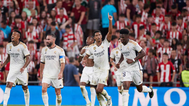 Jude Bellingham pictured raising his left arm to celebrate after scoring his first La Liga goal for Real Madrid in a 2-0 win at Athletic Bilbao in August 2023