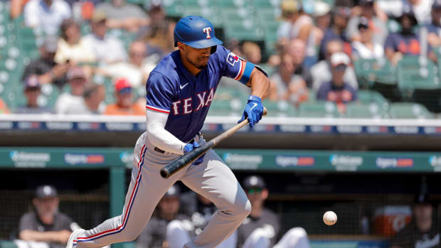 May 31, 2023; Detroit, Michigan, USA; Texas Rangers left fielder Bubba Thompson (8) bunts for a single in the fourth inning against the Detroit Tigers at Comerica Park.
