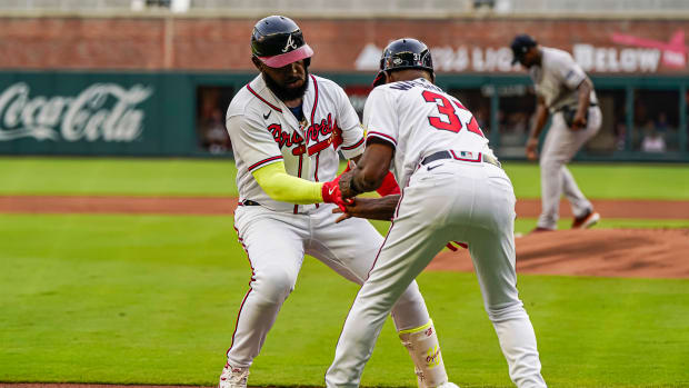 Aug 15, 2023; Cumberland, Georgia, USA; Atlanta Braves designated hitter Marcell Ozuna (20) reacts with third base coach Ron Washington (37) after hitting a home run against the New York Yankees during the first inning at Truist Park.