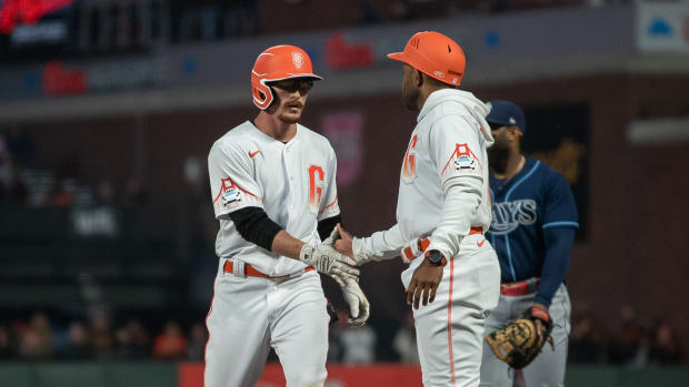 Aug 15, 2023; San Francisco, California, USA; San Francisco Giants right fielder Wade Meckler (53) high fives first base coach Antoan Richardson (00) after getting his first major league hit at Oracle Park. Mandatory Credit: Ed Szczepanski-USA TODAY Sports  