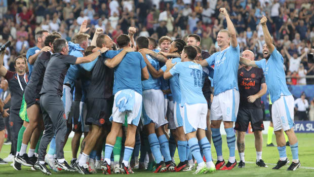 Manchester City's players and coaching staff pictured celebrating after beating Sevilla on penalties in the 2023 UEFA Super Cup final