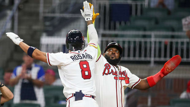 Eddie Rosario celebrates with Marcell Ozuna after a home run