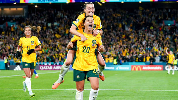 Australia captain Sam Kerr carries teammate Hayley Raso on her back while celebrating Kerr's goal against England in the Women's World Cup semifnals.