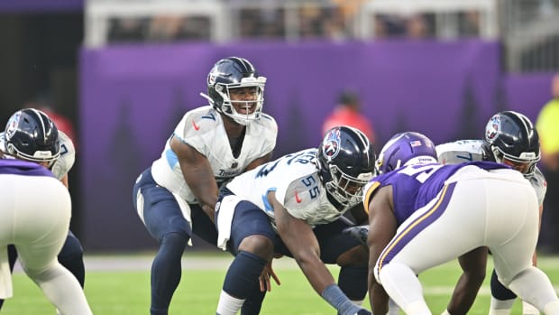 Tennessee Titans quarterback Malik Willis (7) and center Aaron Brewer (55) gets ready for the snap against the Minnesota Vikings during the first quarter at U.S. Bank Stadium.