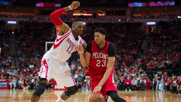 Apr 12, 2015; Houston, TX, USA; Houston Rockets center Dwight Howard (12) defends against New Orleans Pelicans forward Anthony Davis (23) during the second quarter at the Toyota Center. Mandatory Credit: Jerome Miron-USA TODAY Sports