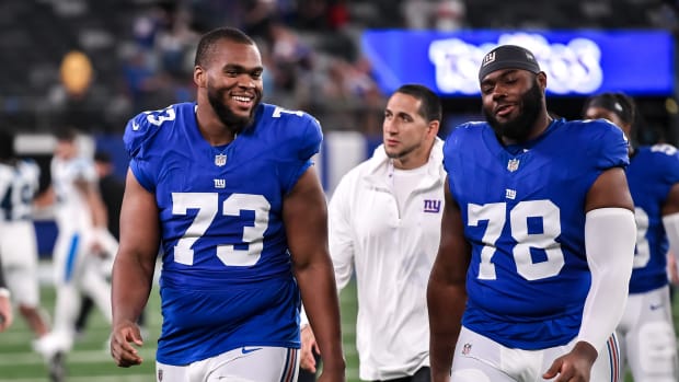 Aug 18, 2023; East Rutherford, New Jersey, USA; New York Giants offensive tackle Evan Neal (73) and New York Giants offensive tackle Andrew Thomas (78) exit the field after defeating the Carolina Panthers at MetLife Stadium.