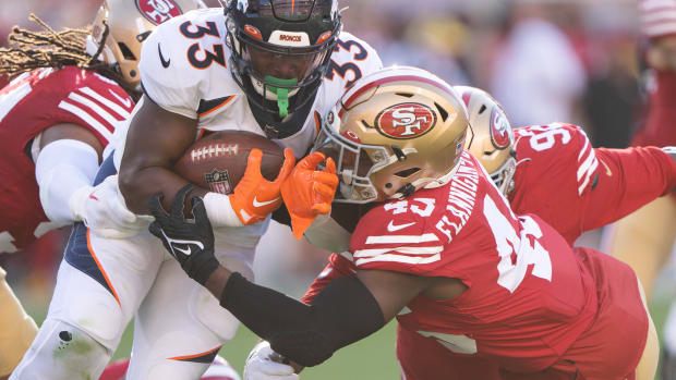 Denver Broncos running back Javonte Williams (33) gets tackled by San Francisco 49ers linebacker Demetrius Flannigan-Fowles (45) during the first quarter at Levi's Stadium.