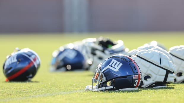 Aug 1, 2023; East Rutherford, NJ, USA; New York Giants helmets rest on the grass field during training camp at the Quest Diagnostics Training Facility.