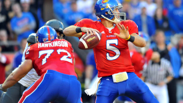 Nov 28, 2009; Kansas City, MO, USA; Kansas Jayhawks quarterback Todd Reesing (5) drops back to pass in the second quarter in the game against the Missouri Tigers at Arrowhead Stadium. Mandatory Credit: Denny Medley-USA TODAY Sports  