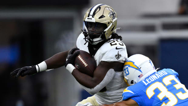 New Orleans Saints running back Kendre Miller (25) runs the ball while defended by Los Angeles Chargers