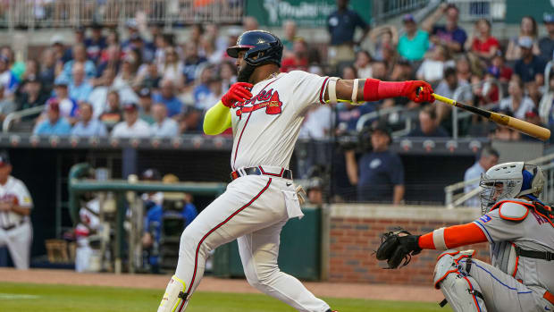 Aug 23, 2023; Cumberland, Georgia, USA; Atlanta Braves designated hitter Marcell Ozuna (20) drives in a run with a single against the New York Mets during the first inning at Truist Park. Mandatory Credit: Dale Zanine-USA TODAY Sports  