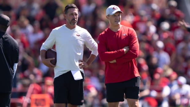 49ers head coach Kyle Shanahan (left) and general manager John Lynch watch the players during training camp practice.