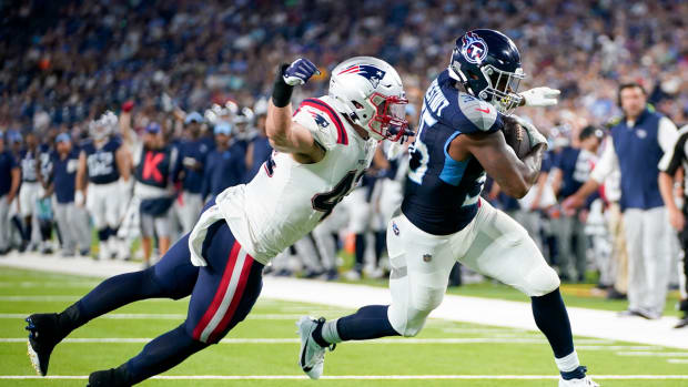 Tennessee Titans running back Julius Chestnut (36) scores a touchdown past New England Patriots linebacker Diego Fagot (42) during the second quarter at Nissan Stadium.