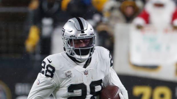 Dec 24, 2022; Pittsburgh, Pennsylvania, USA; Las Vegas Raiders running back Josh Jacobs (28) carries the ball against the Pittsburgh Steelers during the third quarter at Acrisure Stadium. Mandatory Credit: Charles LeClaire-USA TODAY Sports  