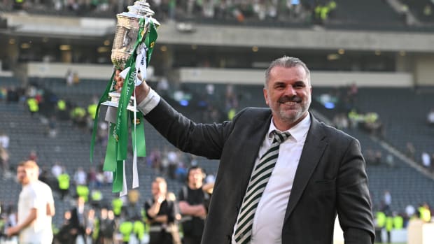 Ange Postecoglou pictured lifting the Scottish Cup trophy after leading Celtic to victory over Inverness in the 2023 final