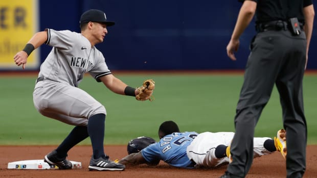 Yankees shortstop Anthony Volpe misses the ball to tag Rays outfielder Randy Arozarena out.