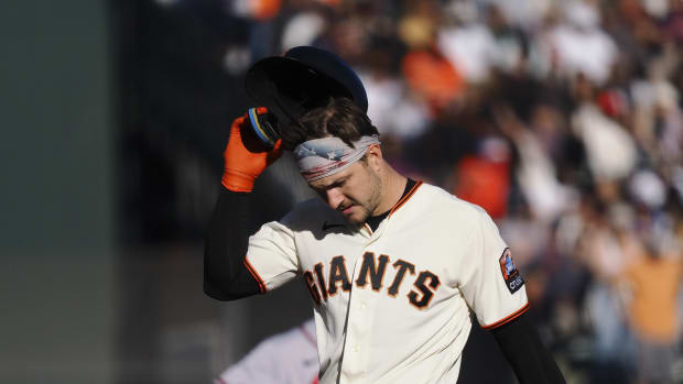 SF Giants catcher Patrick Bailey (14) removes his batting helmet after hitting a three-run RBI double at Oracle Park (2023)