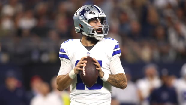Cowboys quarterback Will Grier drops back to pass.