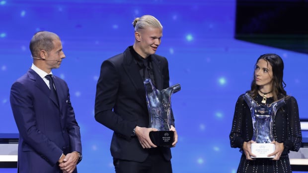 Erling Haaland (center) and Aitana Bonmati (right) pictured holding their UEFA Player of the Year awards in August 2023