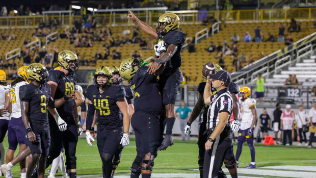 Aug 31, 2023; Orlando, Florida, USA; UCF Knights running back Demarkcus Bowman (23) celebrates with teammates after scoring during the second half against the Kent State Golden Flashes at FBC Mortgage Stadium.