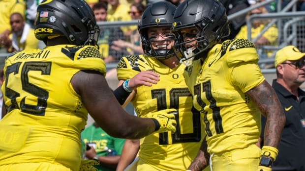 Oregon quarterback Bo Nix (10) celebrates with wide receiver Troy Franklin (11) and offensive lineman Marcus Harper II after Franklin's touchdown during the first half of an NCAA college football game Saturday, Sept. 2, 2023, in Eugene, Ore. (AP Photo/Andy Nelson)   