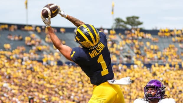 Michigan Wolverines wide receiver Roman Wilson catches a touchdown pass during a college football game.