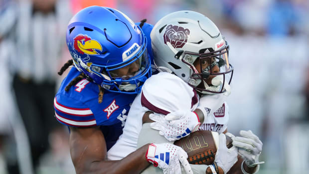 Sep 1, 2023; Lawrence, Kansas, USA; Missouri State Bears wide receiver Raylen Sharpe (6) is tackled by Kansas Jayhawks safety Marvin Grant (4) during the first half at David Booth Kansas Memorial Stadium. Mandatory Credit: Jay Biggerstaff-USA TODAY Sports  
