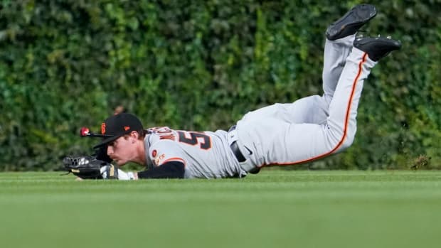 SF Giants center fielder Wade Meckler makes a diving catch against the Chicago Cubs during the first inning at Wrigley Field on September 5, 2023.