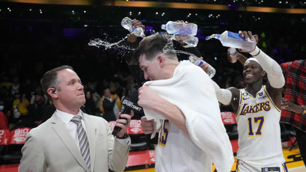 Dennis Schröder douses Austin Reaves with water after a March 2023 Lakers win over the Magic.