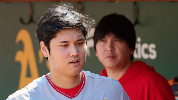 Sep 3, 2023; Oakland, California, USA; Los Angeles Angels designated hitter Shohei Ohtani (17) and interpreter Ippei Mizuhara stand in the dugout before the game between the Los Angeles Angels and the Oakland Athletics at Oakland-Alameda County Coliseum.